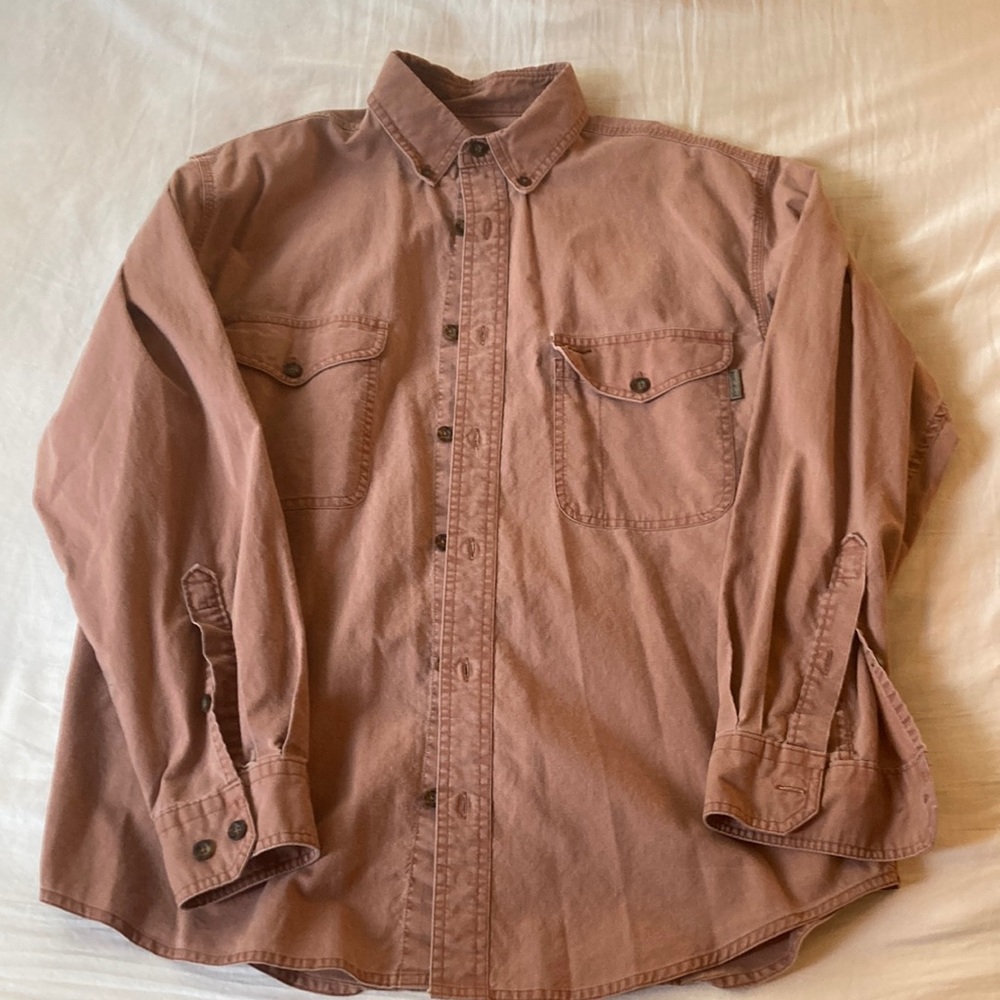Woolrich size medium rust colored longsleeve button down shirt.